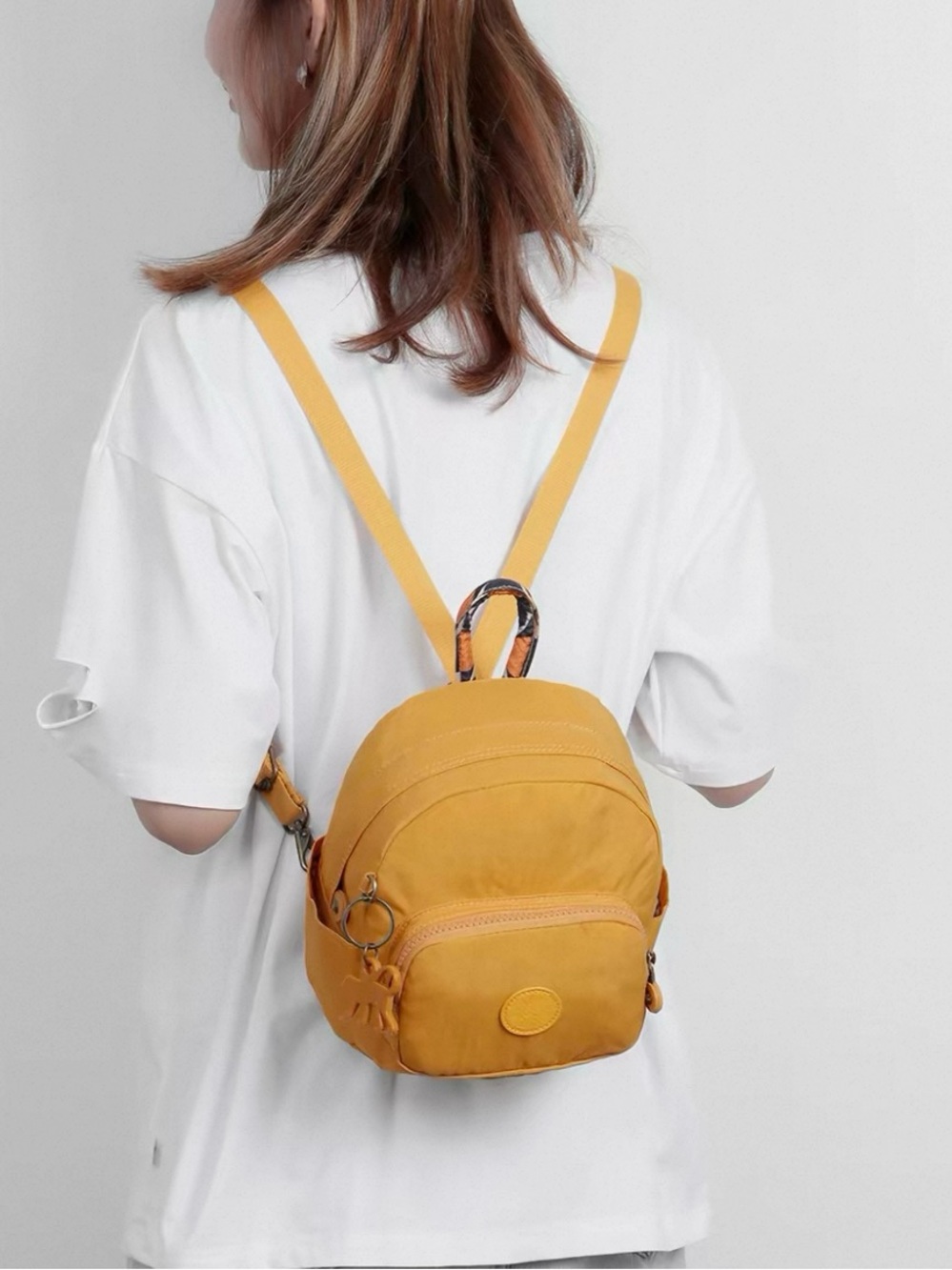Kipling mustard yellow mini backpack with patterned handle